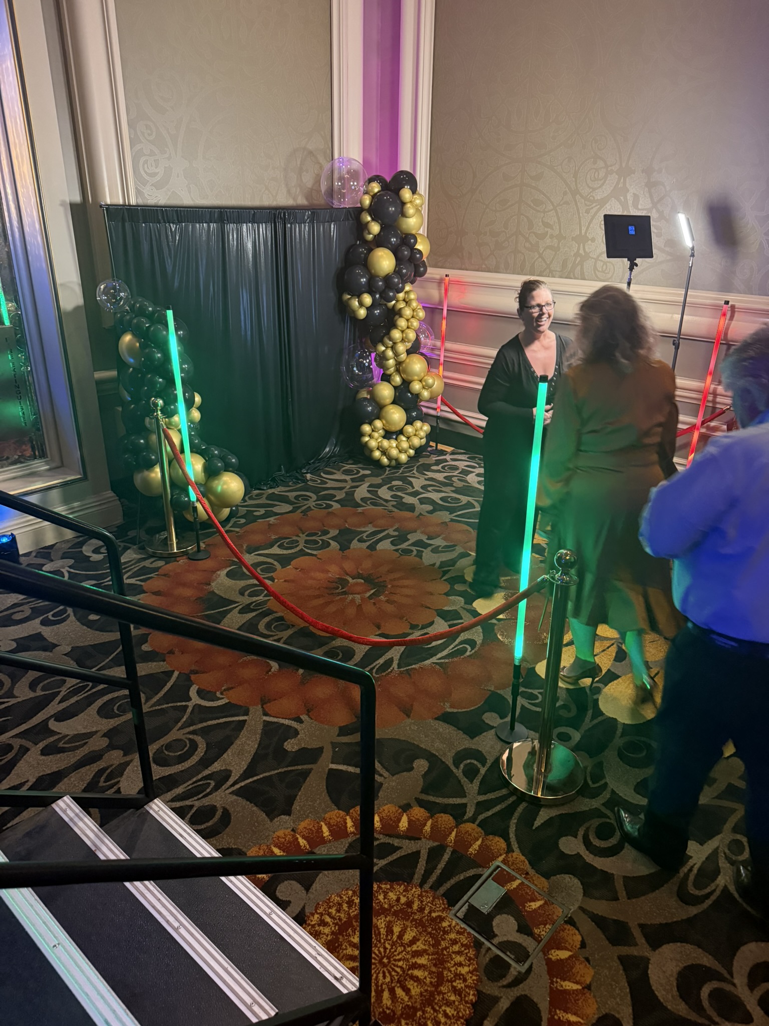 Photo booth with gold balloon arch at hotel ballroom quinceañera in Tucson